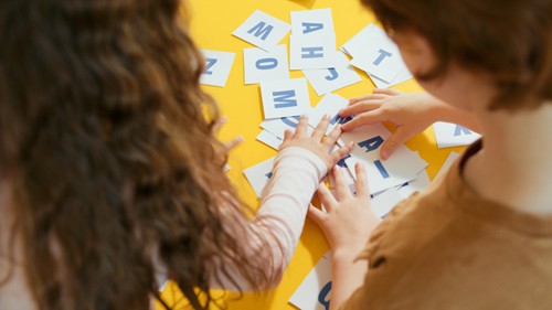 Kids play with letter cards